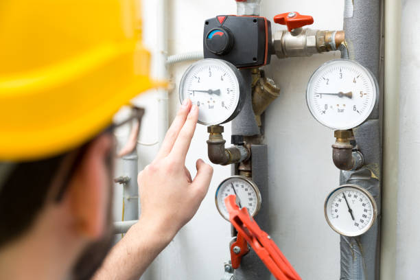 maintenance - technician checking pressure meters for house heating system maintenance - technician checking pressure meters for house heating system gauge pressure gauge pipe valve stock pictures, royalty-free photos & images