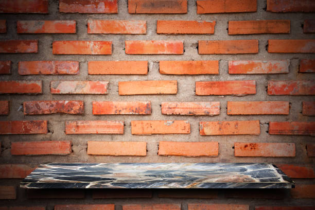 istock Empty top of natural stone shelves and stone wall background. 644231220