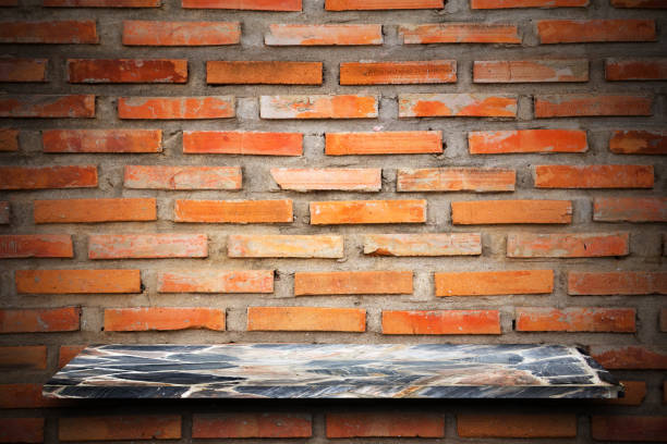 istock Empty top of natural stone shelves and stone wall background. 644231304
