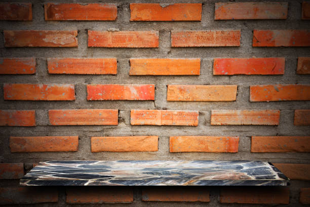 istock Empty top of natural stone shelves and stone wall background. 644231648