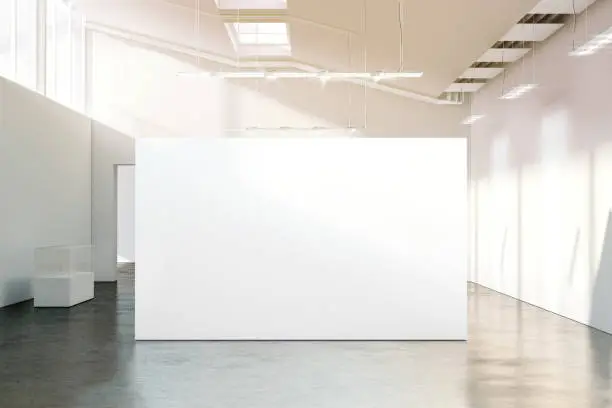 Blank white wall mockup in sunny modern empty museum, 3d rendering. Clear big stand mock up in gallery with contemporary art exhibitions. Large hall interior with wide banner exposition template.