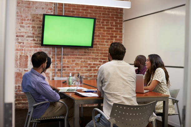 istock Businesspeople In Meeting Room Looking At Screen 644244562