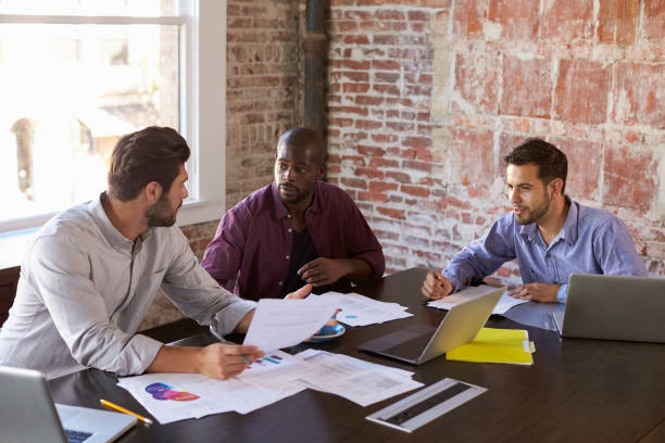 istock Group Of Businessmen Working Together In Boardroom 644244664