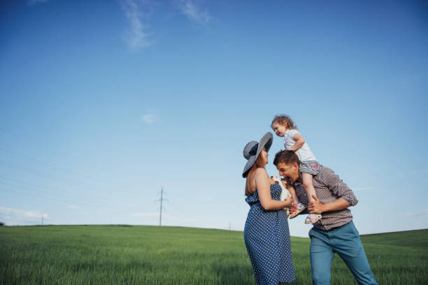 Happy Family Of Three People Hugging In The Streets Stock Photo - Download  Image Now - iStock