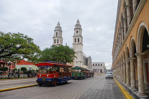 Campeche, Mexico -  February  01, 2010: Independence Plaza, tourist trains and cathedral on the opposite side of the square.