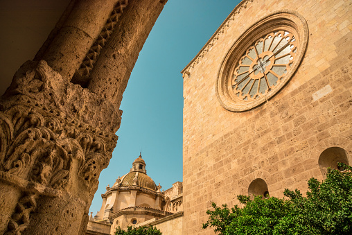Gothic Saint Mary cathedral in Tarragona, Tarragon, seen through an antique arch. Streets of the beautiful medieval old city of Tarragona, Spain.