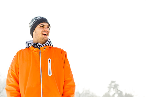Portrait of laughing young man on snow
