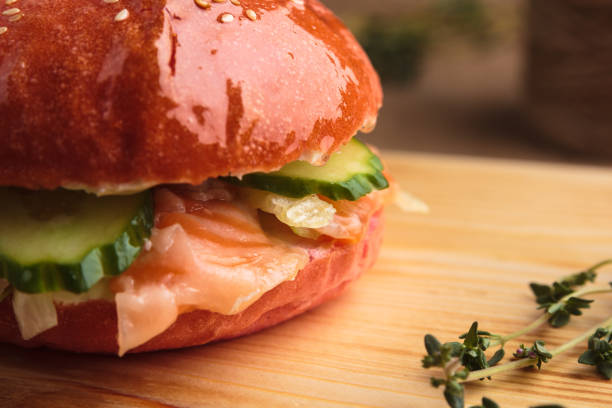 istock Trendy glossy burger with salmon in pink bun 644267898