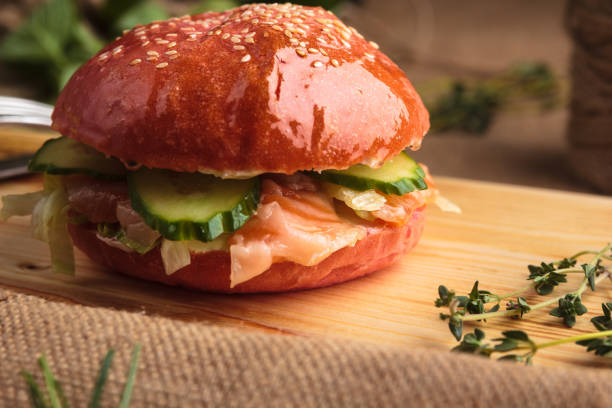 istock Trendy glossy burger with salmon in pink bun 644268088