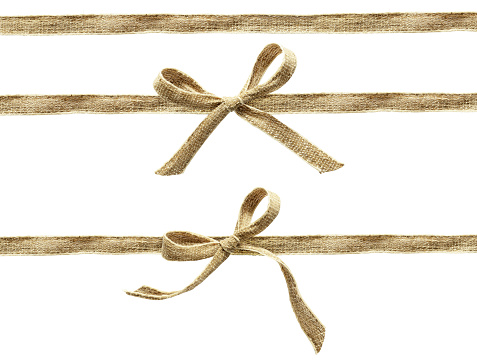 Set of beige canvas ribbons and a bows isolated on white