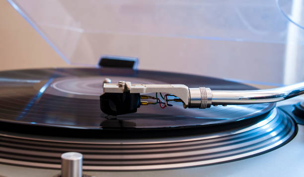 istock Close up of a turntable needle head playing music from an lp.  (shallow focus). 644276066