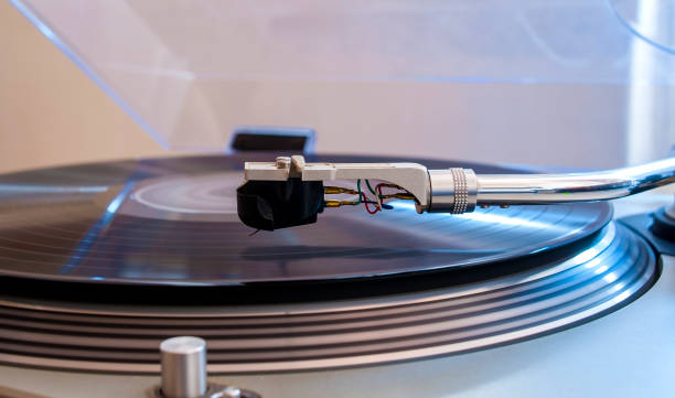 istock Close up of a turntable needle head playing music from an lp.  (shallow focus). 644276068