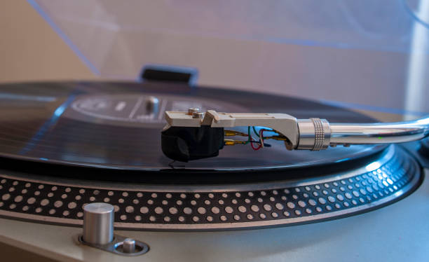 istock Close up of a turntable needle head playing music from an lp.  (shallow focus). 644276082