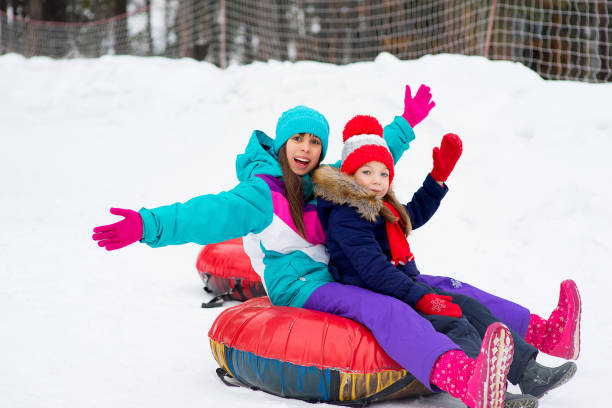 istock Kids on snow tubes downhill at winter day 644276456