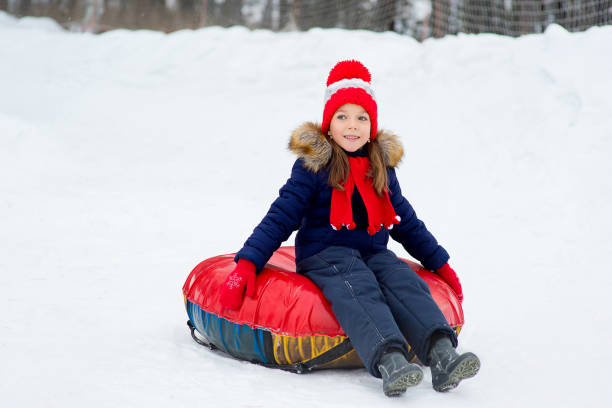 istock Kids on snow tubes downhill at winter day 644276510