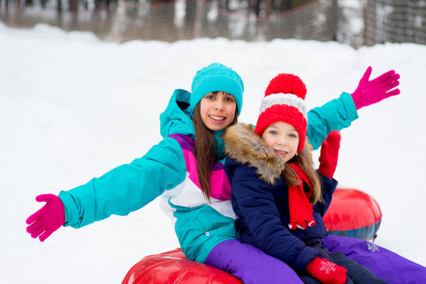 istock Kids on snow tubes downhill at winter day 644276524