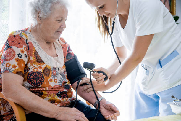 istock Nurse Visiting Senior Woman For Check Up 644282390