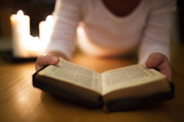 istock Unrecognizable senior woman reading her Bible. 644282502