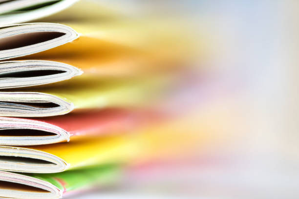 istock colorful magazine stacking with  blurry bookshelf background 644282742