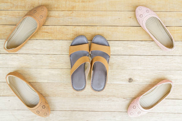 istock Female shoes on wood background 644282770