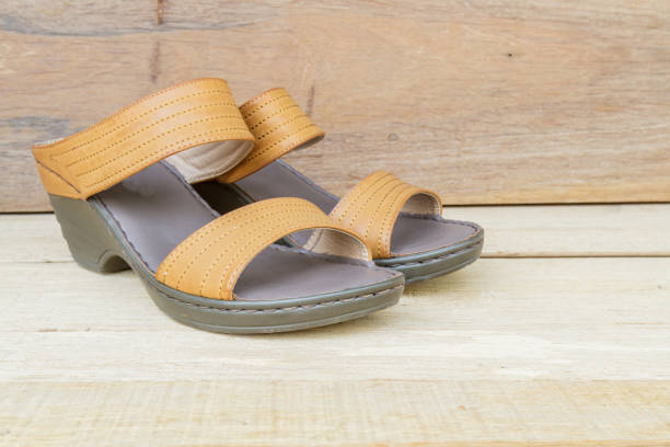 istock Female shoes on wood background 644282792