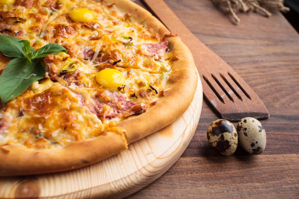istock Pizza carbonara on a wooden vintage table 644286526