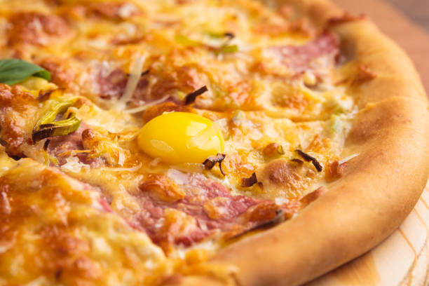 Pizza carbonara on a wooden vintage table