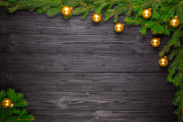 istock Christmas fir tree on black wooden background 644292426