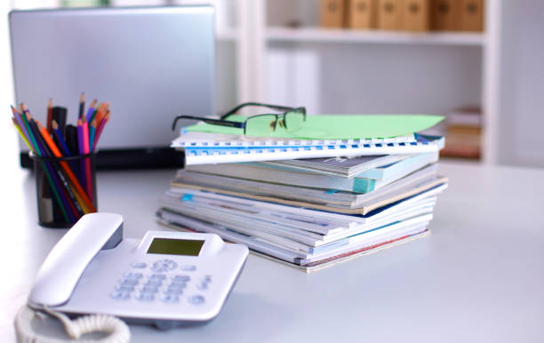 istock A note book, laptop, pen, graph paper document on the office desk table behind white blind 644292560