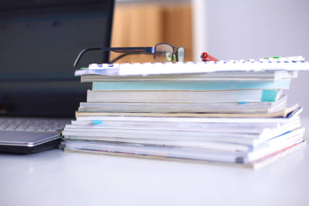 istock A note book, laptop, pen, graph paper document on the office desk table behind white blind 644297760