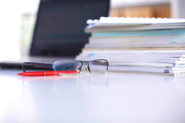 istock A note book, laptop, pen, graph paper document on the office desk table behind white blind 644297966