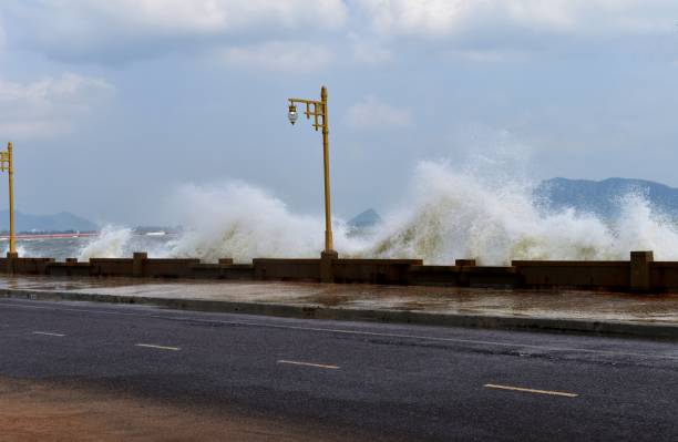 istock Waves breaking,Big strong wave moved ashore on the road along the sea 644305808
