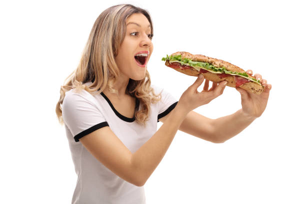 istock Young woman eating a sandwich 644311880