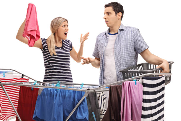 istock Young couple having an argument while hanging clothes 644312030