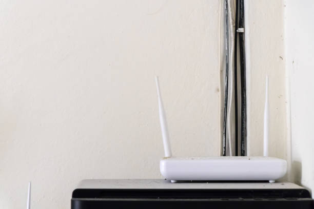 istock Wi-Fi wireless router with cement wall background 644320468