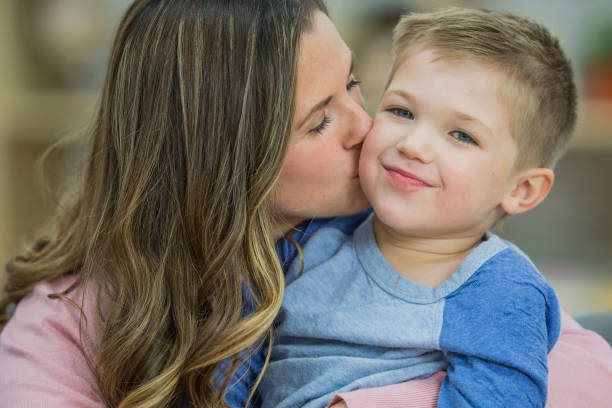 istock Mother Giving Her Son a Kiss 644324640