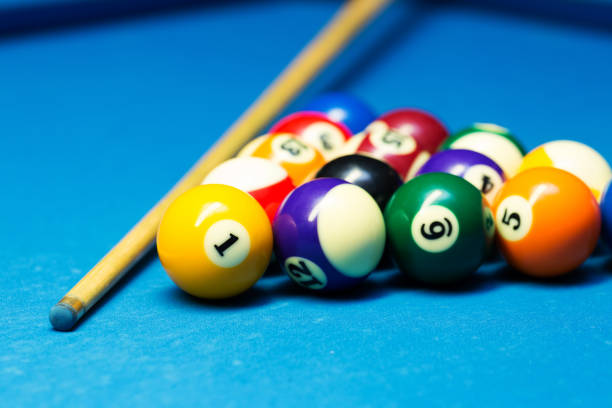 istock pool billiard balls and cue on the blue cloth table 644328318