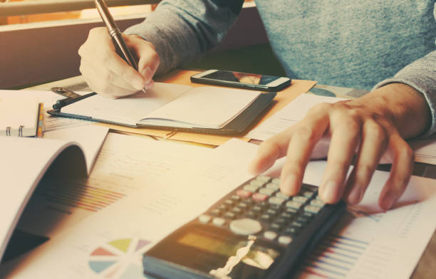 istock Calculator with hand man doing finance and calculate on desk 644349910