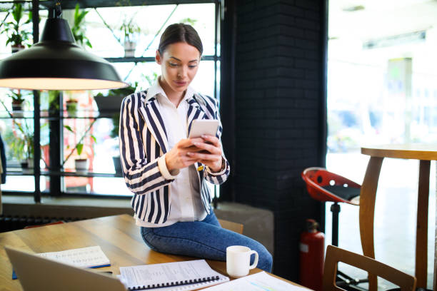 istock Young casual businesswoman using mobile in the office. 644358590