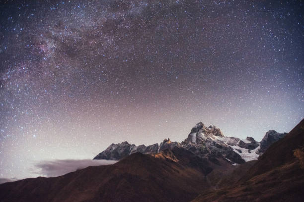 istock Fantastic starry sky. Autumn landscape and snow-capped peaks 644358844