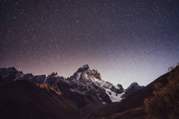 istock Fantastic starry sky. Autumn landscape and snow-capped peaks 644358898