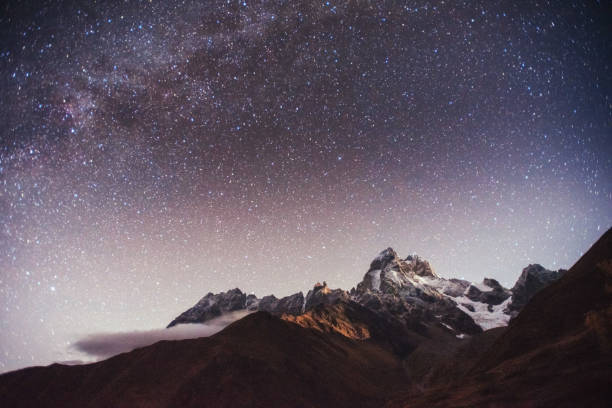 istock Fantastic starry sky. Autumn landscape and snow-capped peaks 644358976
