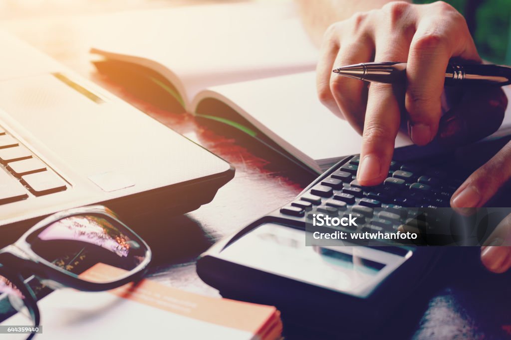 Close up woman doing finance with calculate expenses. Close up woman doing finance at home office with calculate expenses. Tax Form Stock Photo