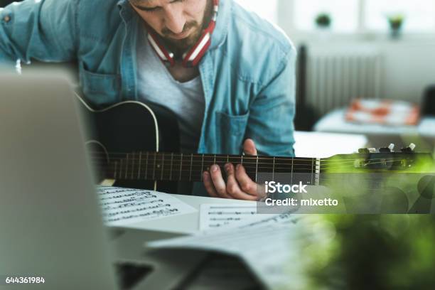 Learning To Play Guitar Stock Photo - Download Image Now - 25-29 Years, Acoustic Guitar, Adult