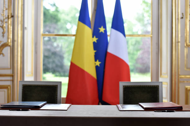 istock EU and Romania flags during a treaty sign 644377780