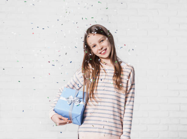 istock Happy girl with falling confetti at party 644392136