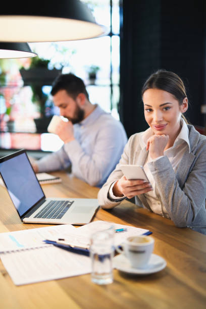istock Businesswoman using mobile phone in the office 644400934