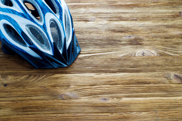istock Bicycle helmet on a wooden background. 644404246