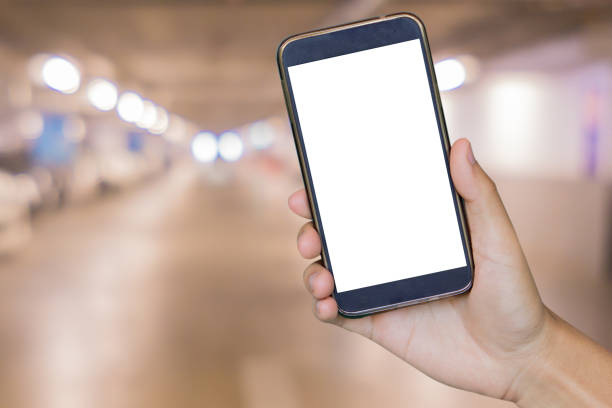 istock hand holding mobile smart phone,over Blur of backgrond 644412458