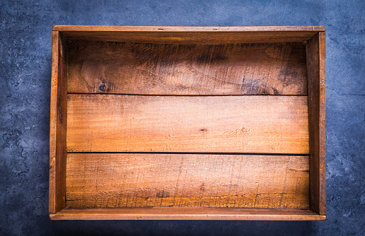 Vintage wooden box empty on dark background copy space directly above.